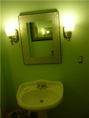 Finished bathroom vanity with mirrored medicine cabinet and pedestal sink
