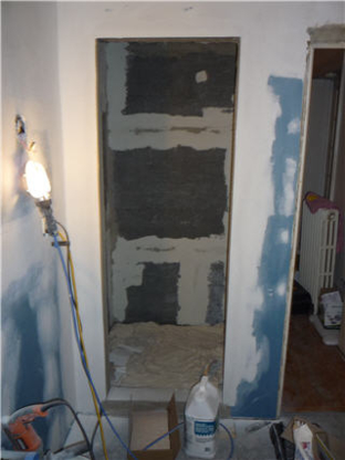 Wall cavity mid-renovation with cement backer board ready for tile