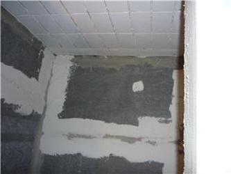 Ceiling and wall corner mid-renovation with patched drywall sections
